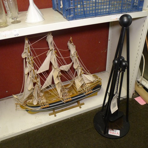 3001A - A Manor Teepee black metal three piece fireside companion set approx 66cm high (unsued) and a Hanah ... 