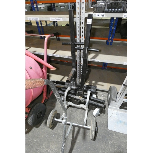 A black metal two part wheeled frame (for dispensing floor coverings ...