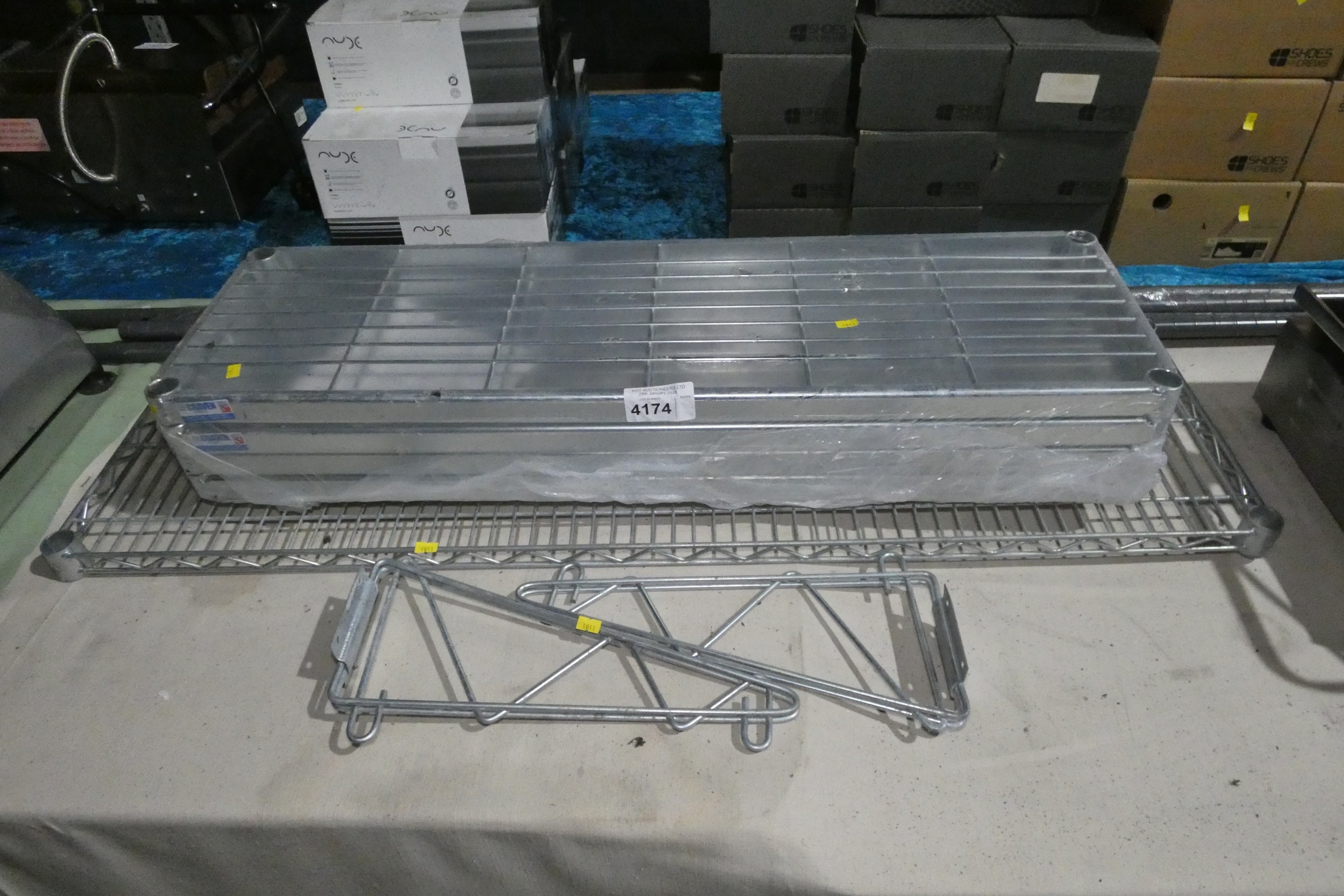 A catering type rack with 4 shelves and a wall mounted shelf with brackets