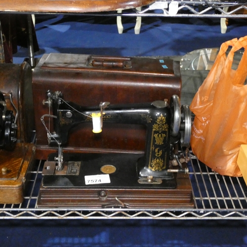 A vintage hand sewing machine with carry case