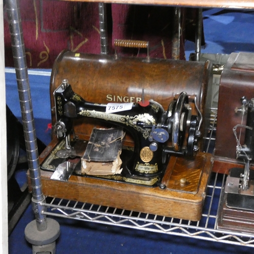 A vintage Singer hand sewing machine with carry case