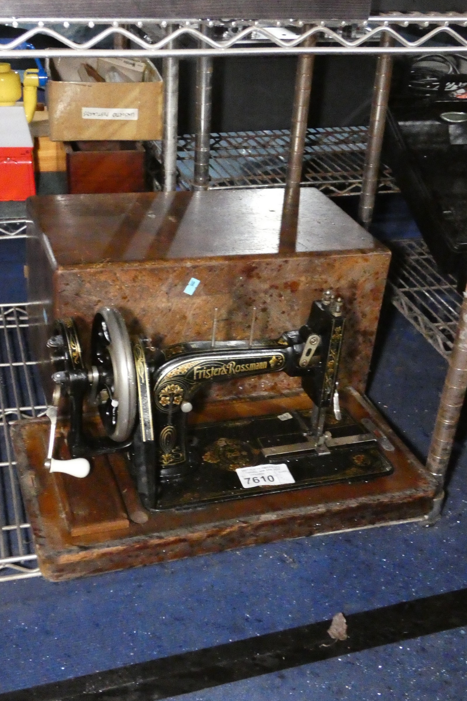 A vintage hand sewing machine in carry case