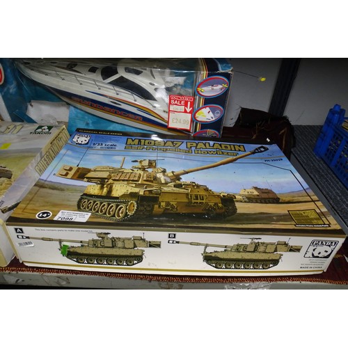 Two boxed vintage model tank kits, to be assembled and a vintage model boat