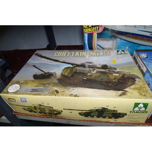 Two boxed vintage model tank kits, to be assembled and a vintage model boat