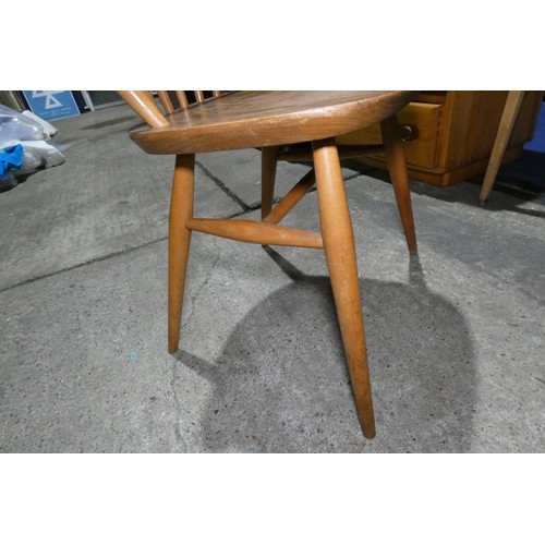 7391 - A mid 20th century Ercol blonde wood small writing desk with two trinket drawers, one drawer below a... 
