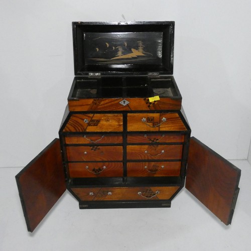 7552 - A miniature table top oriental cabinet with two doors enclosing small drawers