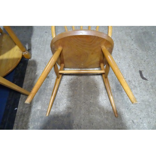 7391 - A mid 20th century Ercol blonde wood small writing desk with two trinket drawers, one drawer below a... 