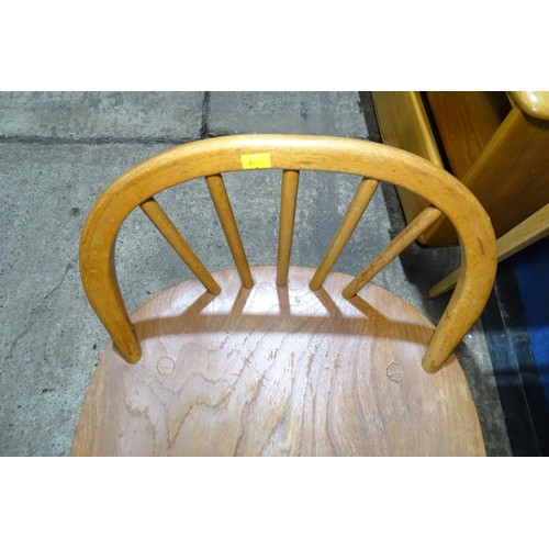 7391 - A mid 20th century Ercol blonde wood small writing desk with two trinket drawers, one drawer below a... 