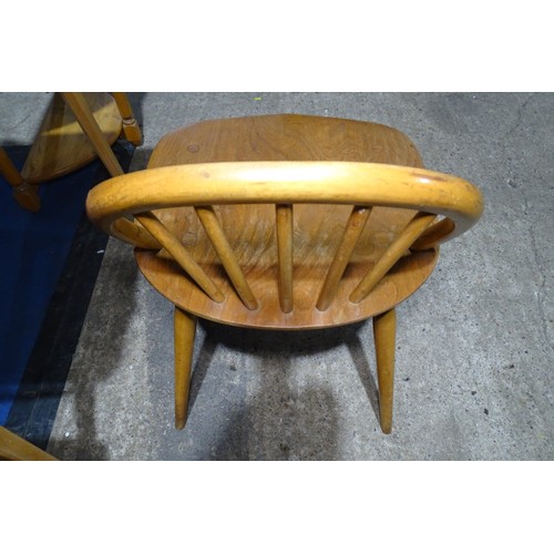 7391 - A mid 20th century Ercol blonde wood small writing desk with two trinket drawers, one drawer below a... 