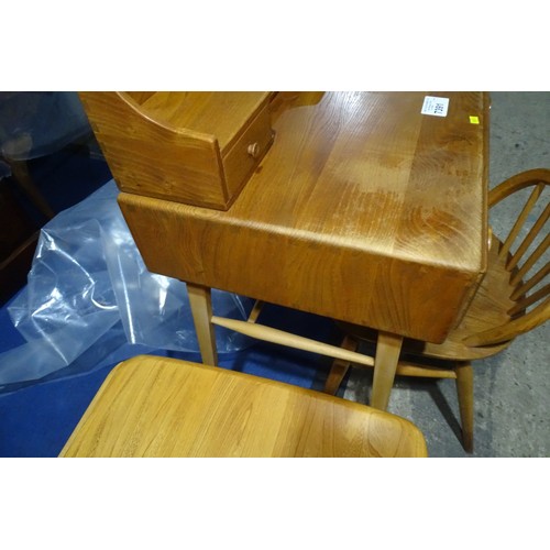 7391 - A mid 20th century Ercol blonde wood small writing desk with two trinket drawers, one drawer below a... 