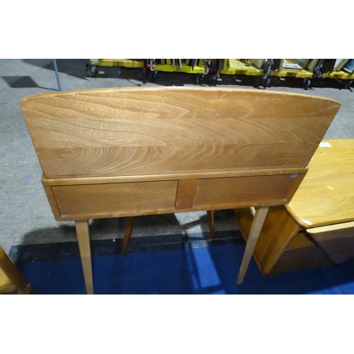 7391 - A mid 20th century Ercol blonde wood small writing desk with two trinket drawers, one drawer below a... 