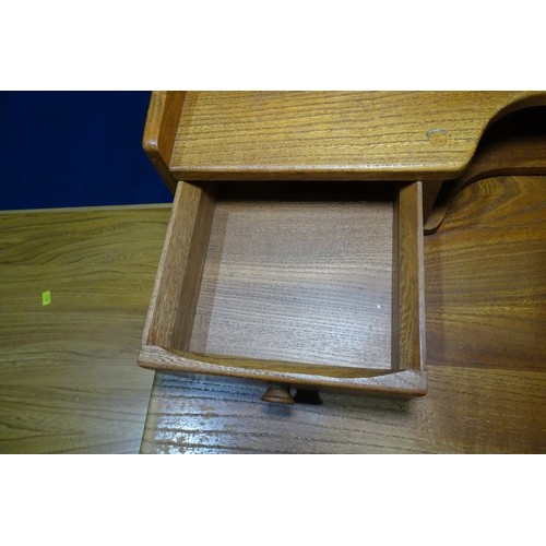 7391 - A mid 20th century Ercol blonde wood small writing desk with two trinket drawers, one drawer below a... 