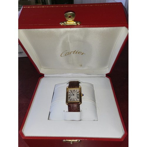 4212 - A Cartier Tank Solo small model gold & steel cased watch with quartz movement & leather stra... 