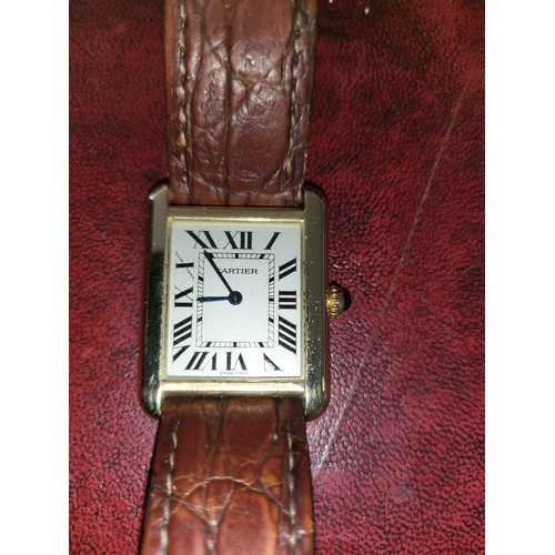 4212 - A Cartier Tank Solo small model gold & steel cased watch with quartz movement & leather stra... 