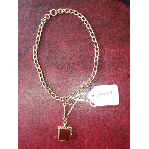 4210 - A 9 carat yellow gold Albert T bar chain and agate fob pendant, approximately 38cms long, weight app... 