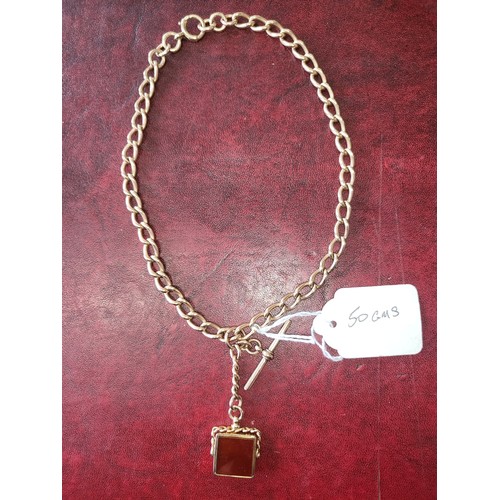 4210 - A 9 carat yellow gold Albert T bar chain and agate fob pendant, approximately 38cms long, weight app... 