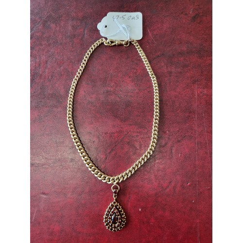 4211 - A 9 ct. yellow gold neck chain with pear shaped garnet pendant, approximately 36cms long, weight app... 