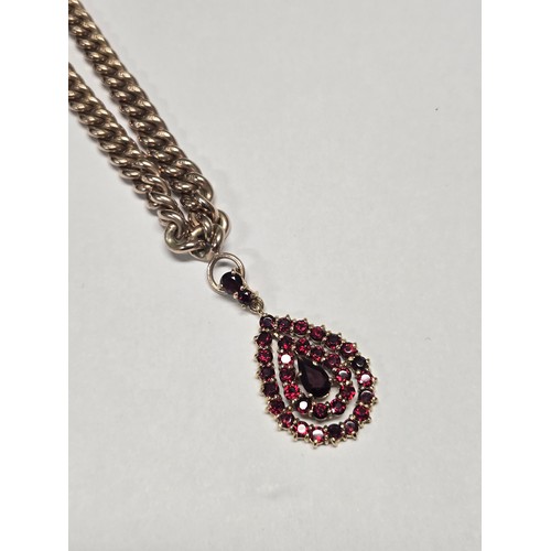 4211 - A 9 ct. yellow gold neck chain with pear shaped garnet pendant, approximately 36cms long, weight app... 