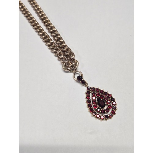4211 - A 9 ct. yellow gold neck chain with pear shaped garnet pendant, approximately 36cms long, weight app... 