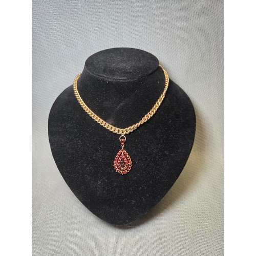 4211 - A 9 ct. yellow gold neck chain with pear shaped garnet pendant, approximately 36cms long, weight app... 
