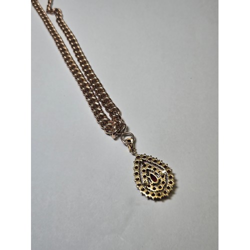 4211 - A 9 ct. yellow gold neck chain with pear shaped garnet pendant, approximately 36cms long, weight app... 