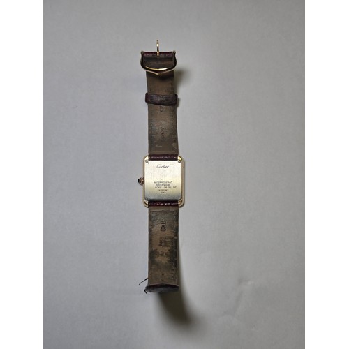 4212 - A Cartier Tank Solo small model gold & steel cased watch with quartz movement & leather stra... 