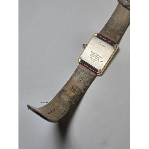 4212 - A Cartier Tank Solo small model gold & steel cased watch with quartz movement & leather stra... 
