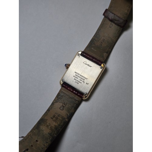 4212 - A Cartier Tank Solo small model gold & steel cased watch with quartz movement & leather stra... 