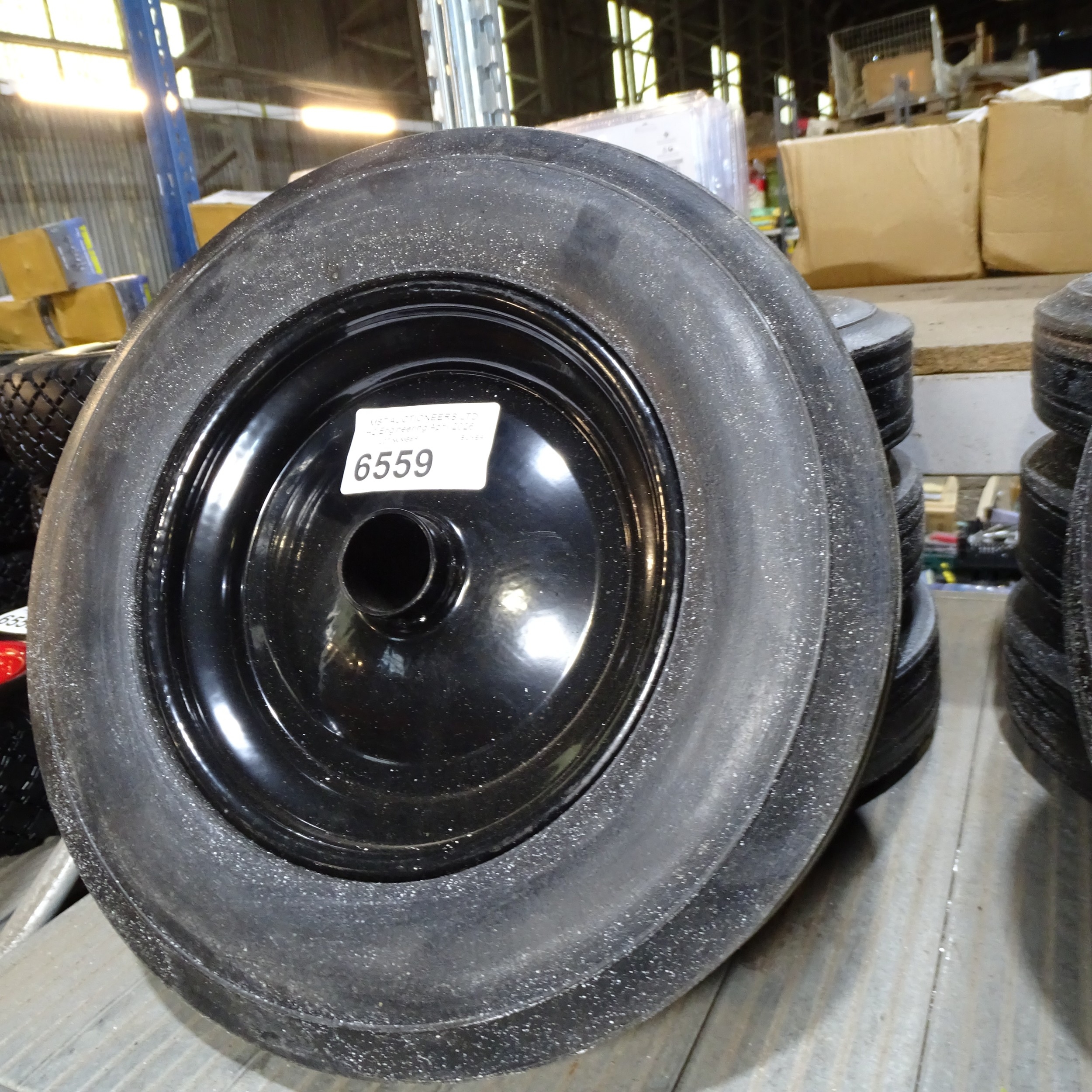4 x small black metal wheels fitted with BIL solid rubber tyres with no ...