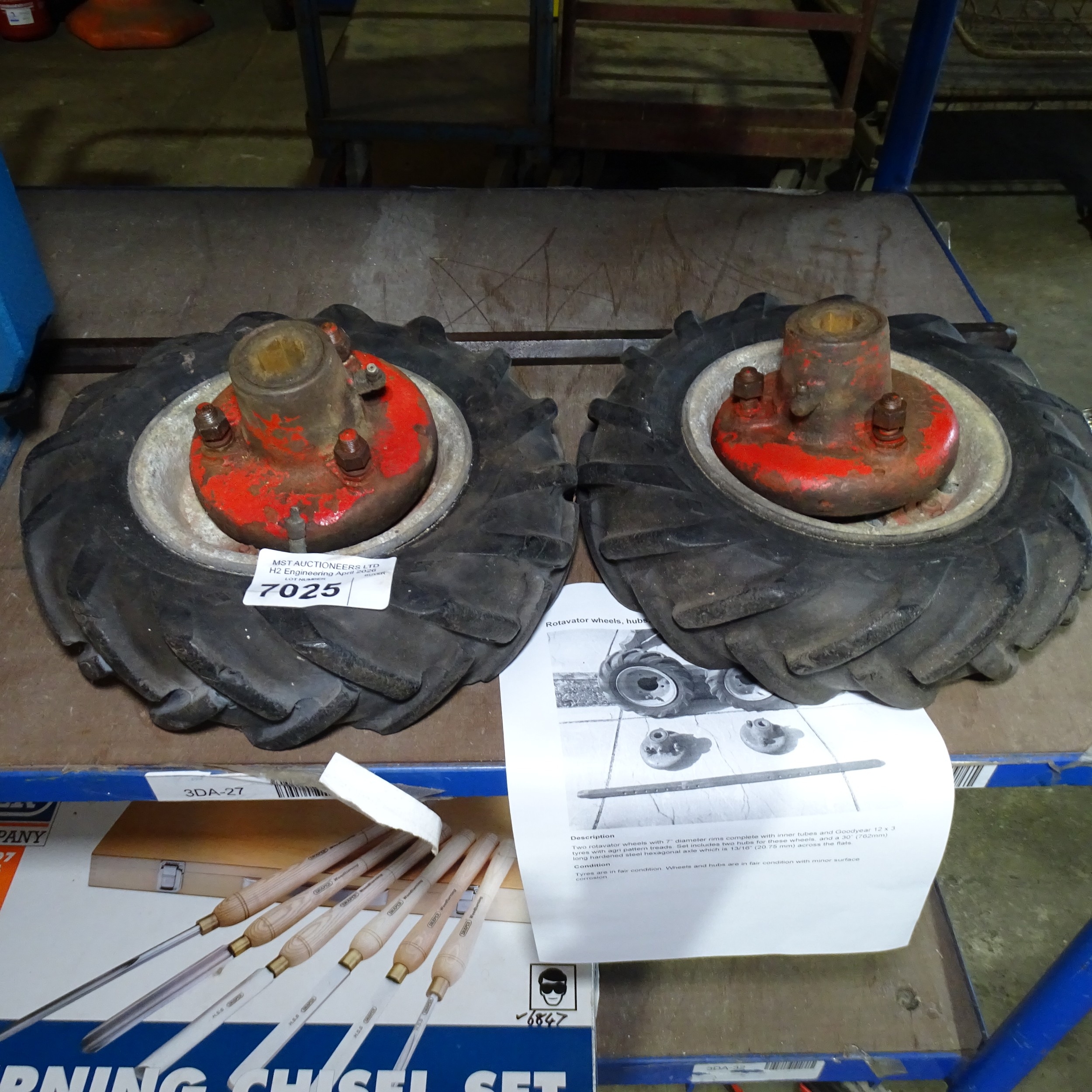 A pair of rotavator wheels with a pair of hubs