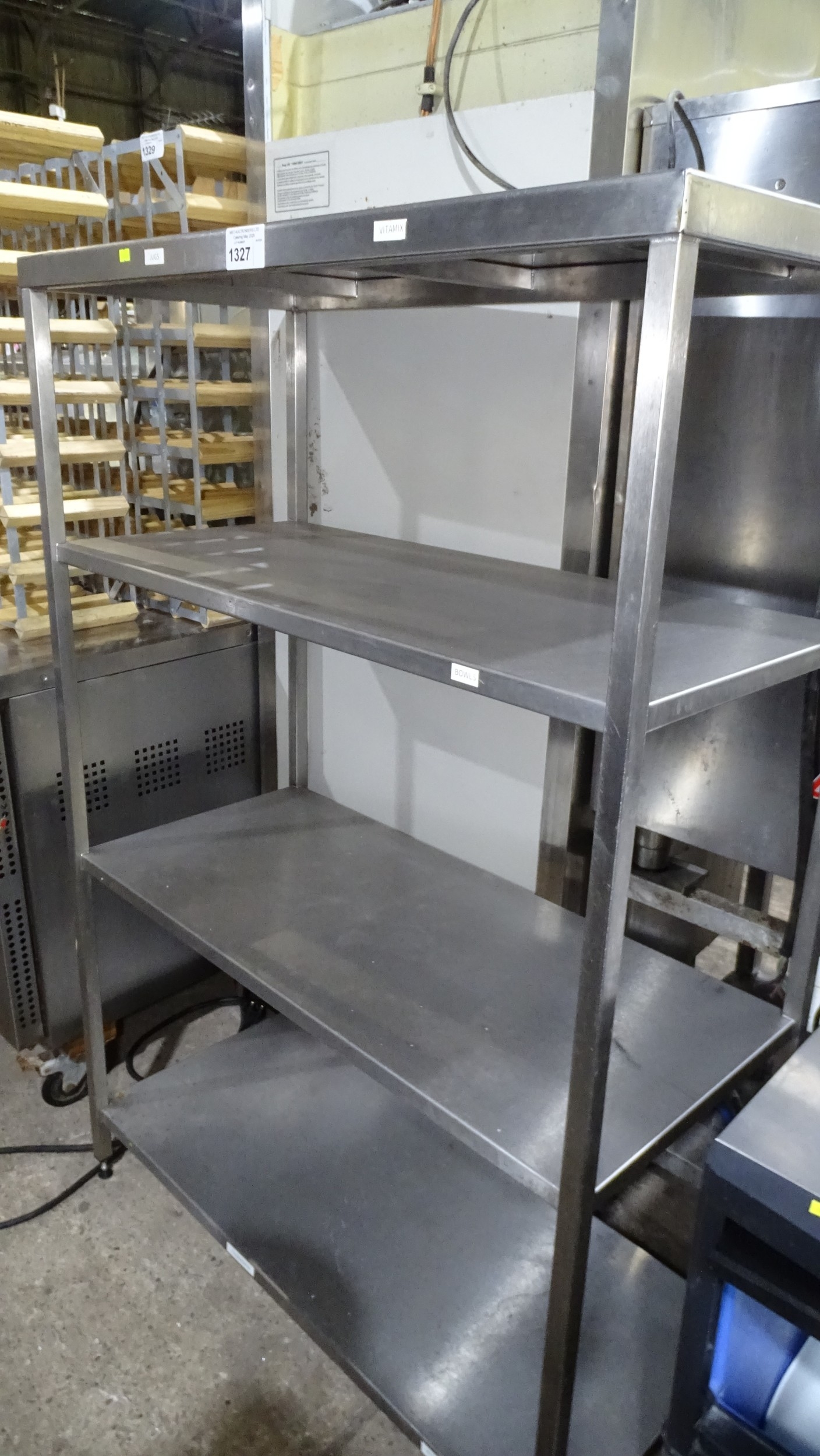 A commercial stainless steel catering type rack with 4 fixed shelves ...