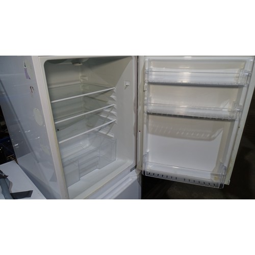 1295 - A fridge freezer by Beko A-class trade. Tested Working