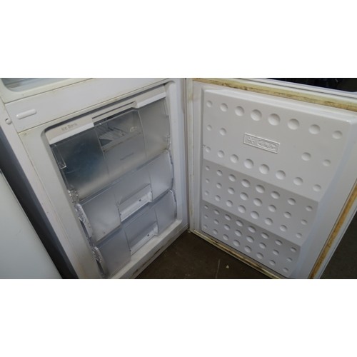 1295 - A fridge freezer by Beko A-class trade. Tested Working