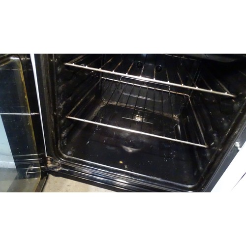 1297 - An electric oven by Indesit - 4 ring hob with grill and oven below Trade
