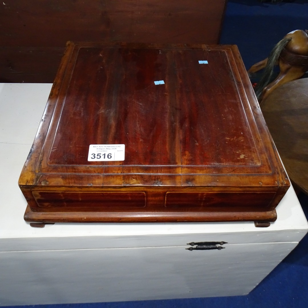 An Oriental hardwood table top box with a lift lid enclosing ...