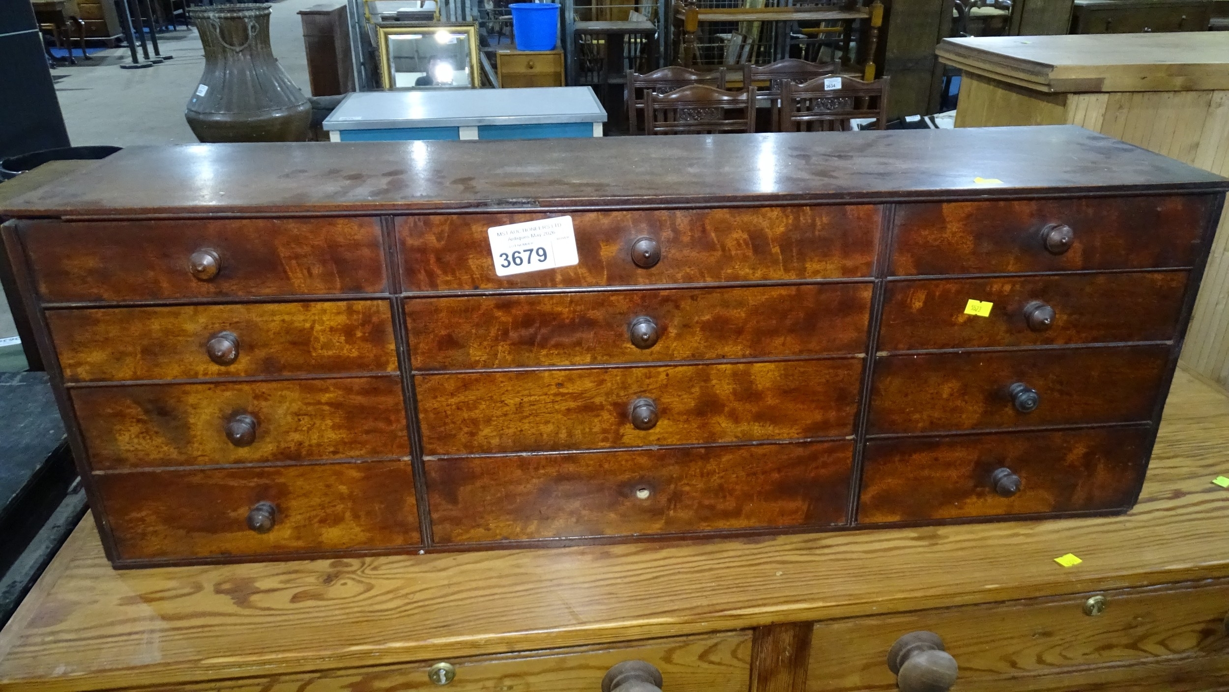 A small table top multi-drawer chest of 12 drawers with small-turned ...