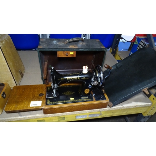 A vintage singer hand sewing machine in carry case