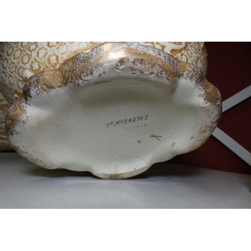 5026 - A pair of ornate ivory coloured pottery vases with raised scrollwork