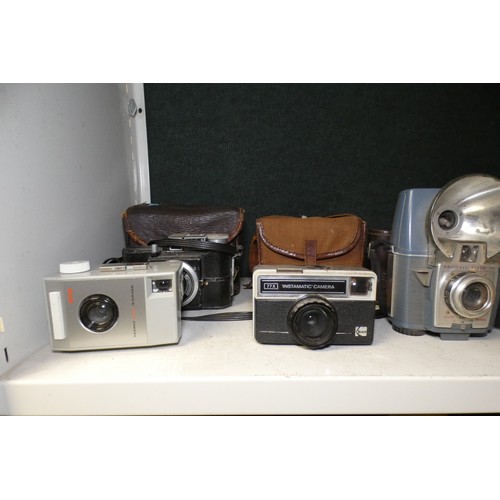5053 - A large quantity of miscellaneous vintage cameras including; early box cameras, folding bellows came... 