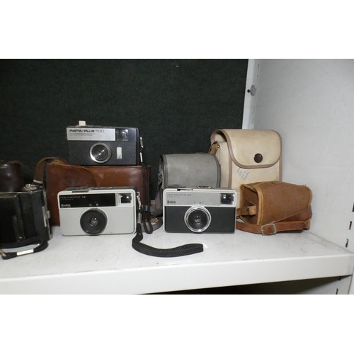 5053 - A large quantity of miscellaneous vintage cameras including; early box cameras, folding bellows came... 