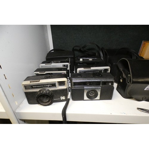 5053 - A large quantity of miscellaneous vintage cameras including; early box cameras, folding bellows came... 