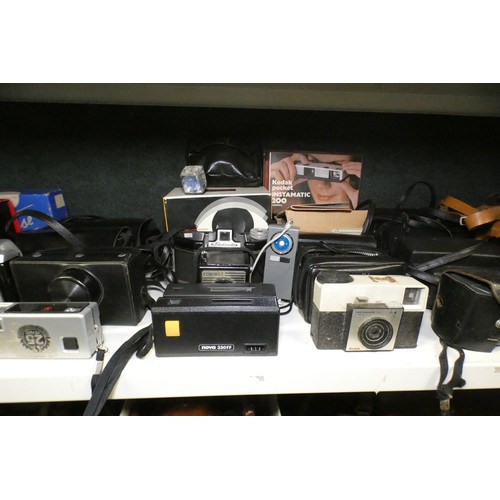 5053 - A large quantity of miscellaneous vintage cameras including; early box cameras, folding bellows came... 