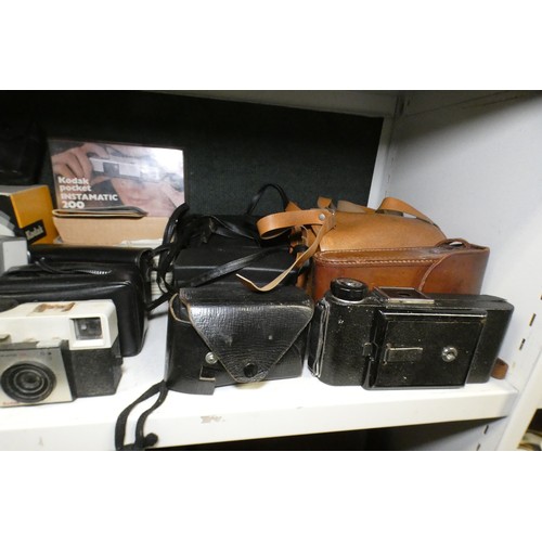 5053 - A large quantity of miscellaneous vintage cameras including; early box cameras, folding bellows came... 