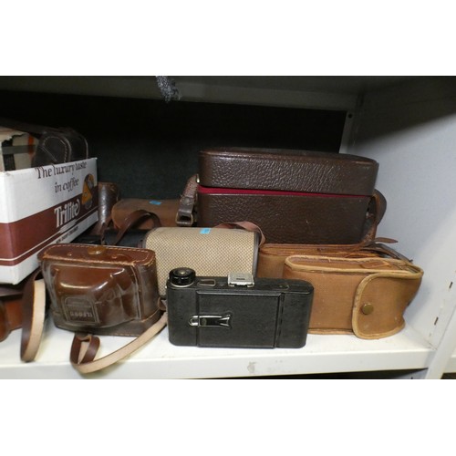 5053 - A large quantity of miscellaneous vintage cameras including; early box cameras, folding bellows came... 