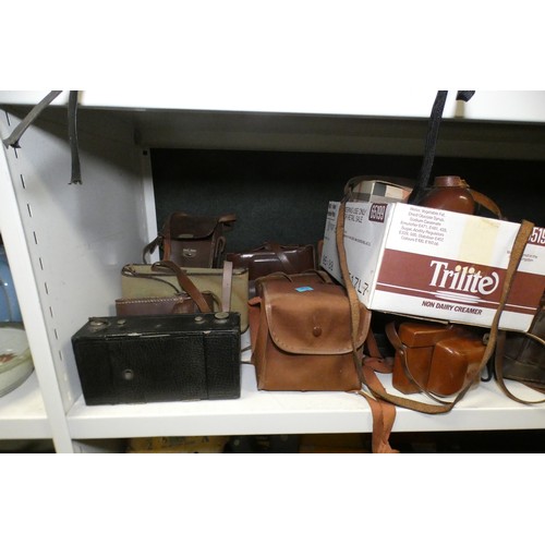 5053 - A large quantity of miscellaneous vintage cameras including; early box cameras, folding bellows came... 