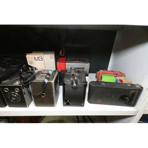 5053 - A large quantity of miscellaneous vintage cameras including; early box cameras, folding bellows came... 