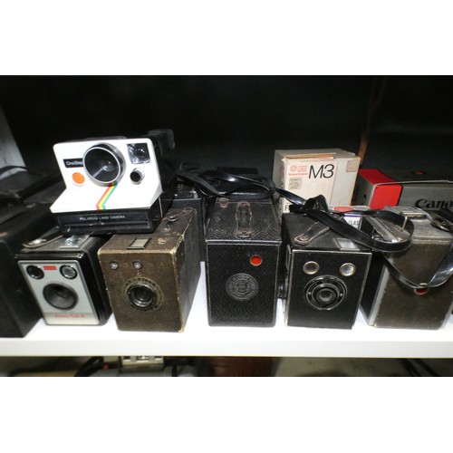 5053 - A large quantity of miscellaneous vintage cameras including; early box cameras, folding bellows came... 