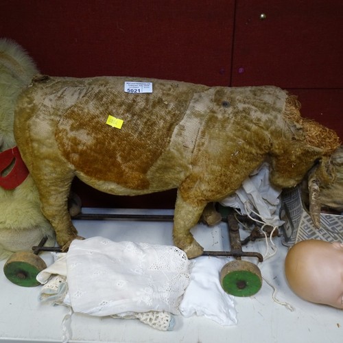 5021 - A quantity of miscellaneous vintage soft toys and a porcelain head doll. Note Cows head is damaged. ... 