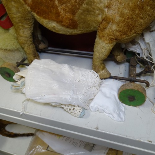 5021 - A quantity of miscellaneous vintage soft toys and a porcelain head doll. Note Cows head is damaged. ... 