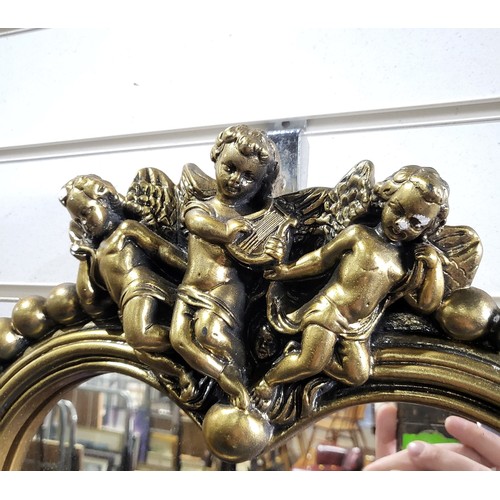 A Vintage Gilt Heart shaped hall mirror with cupids above a bobbin frame.